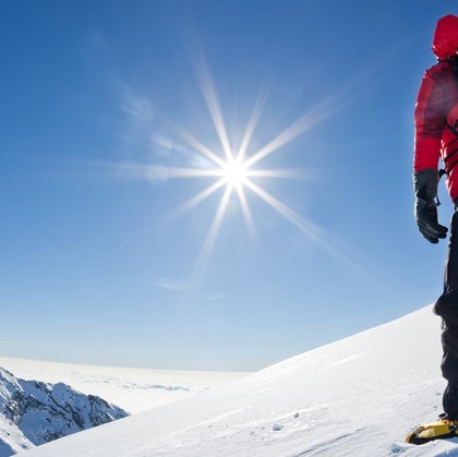 Mountaineer reaches the top of mountain.